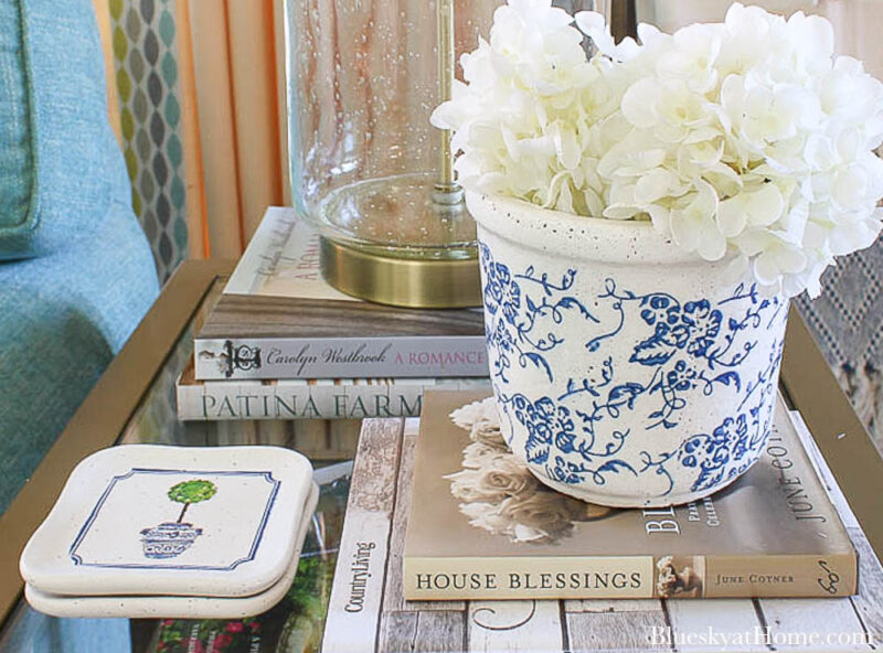 tile coasters on table with blue planter