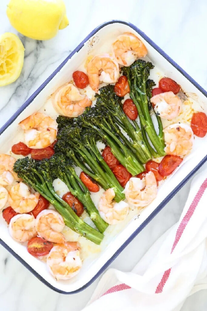 shrimp, broccolini, tomatoes on pan