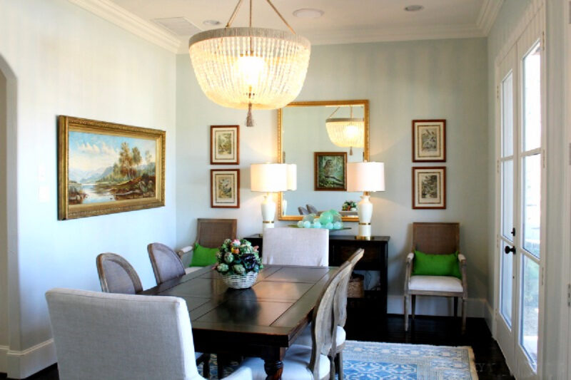 dining room with large light fixture and large mirror