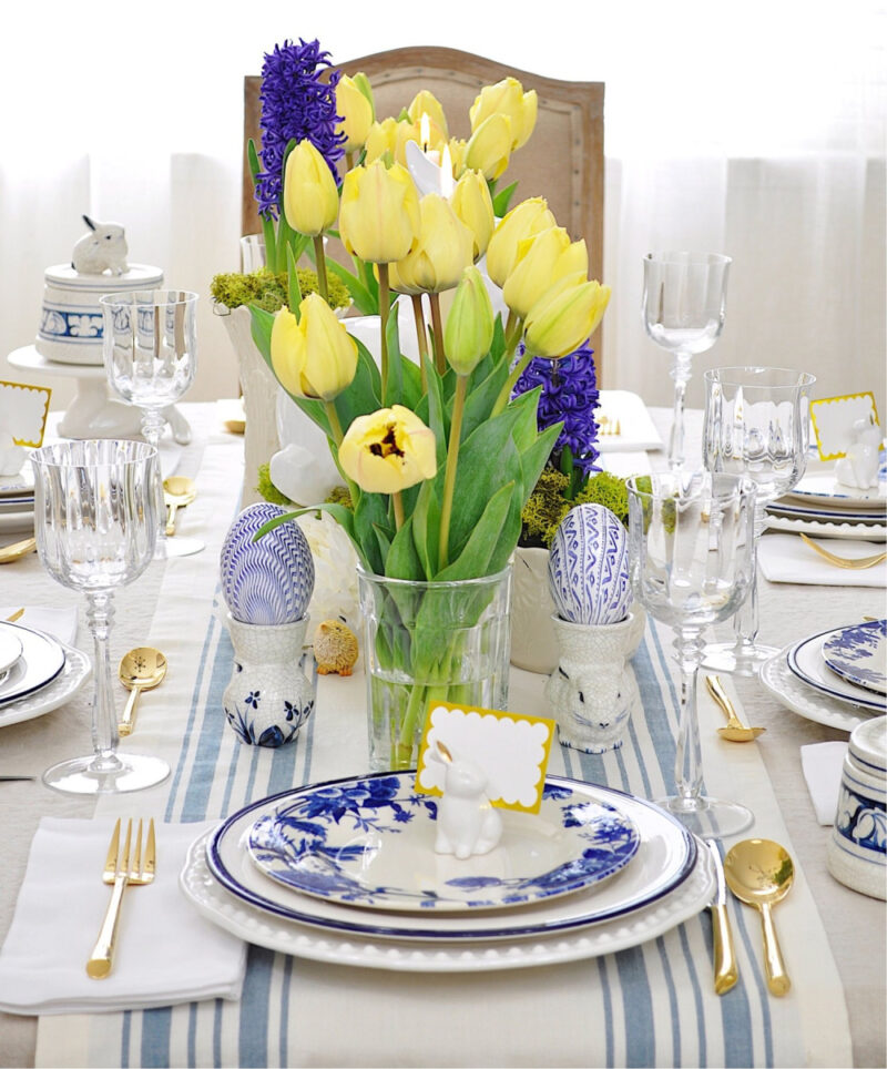 Easter tablescape with yellow tulips and blue dishes