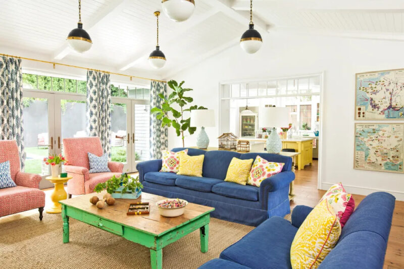 summer home decor idea of blue sofa with yellow pillows