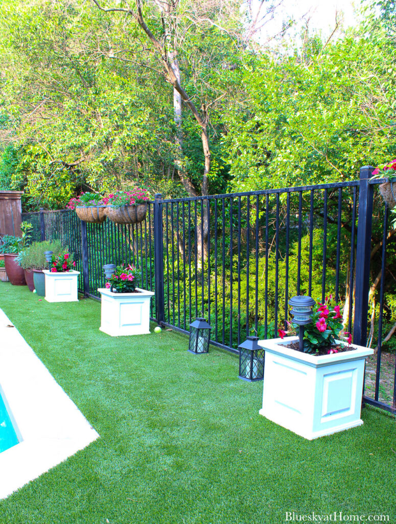 white planters on green grass