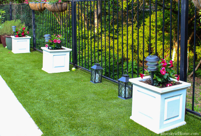 white planters and green grass