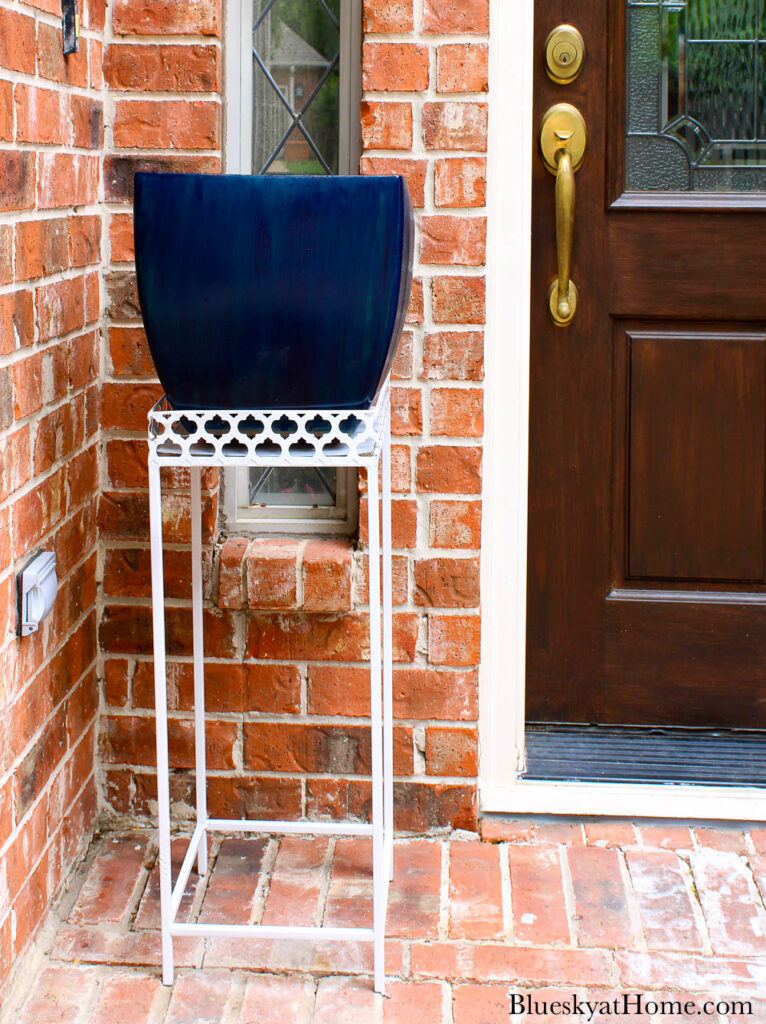 white plant stand with blue planter