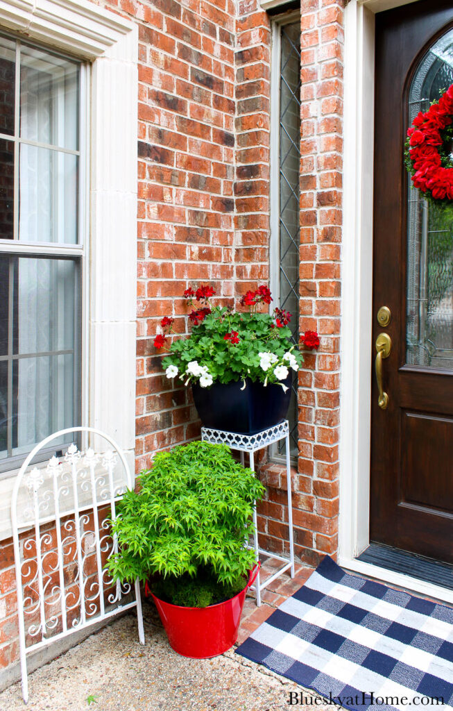 finished white plant stand and bule palnter