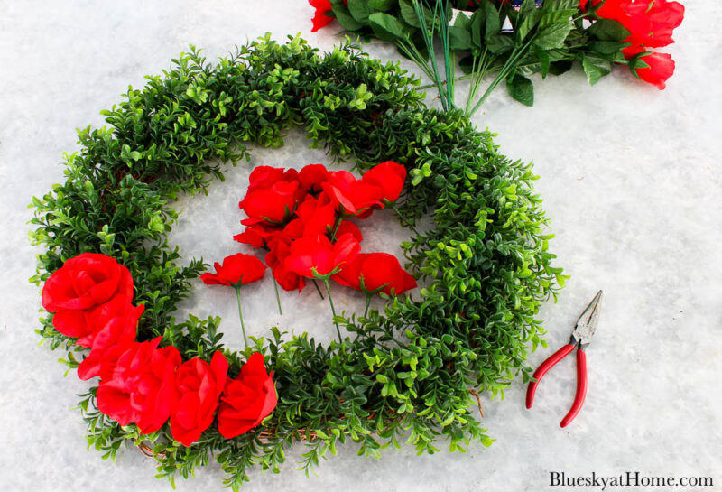 faux red roses and boxwood wreath