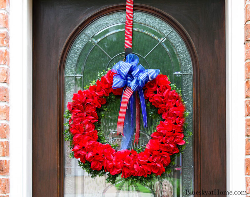 summer styled front door with red rose wreath