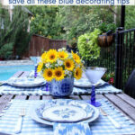 A vibrant outdoor table setting features blue design elements and sunflowers, embodying classic blue home decor for all seasons.