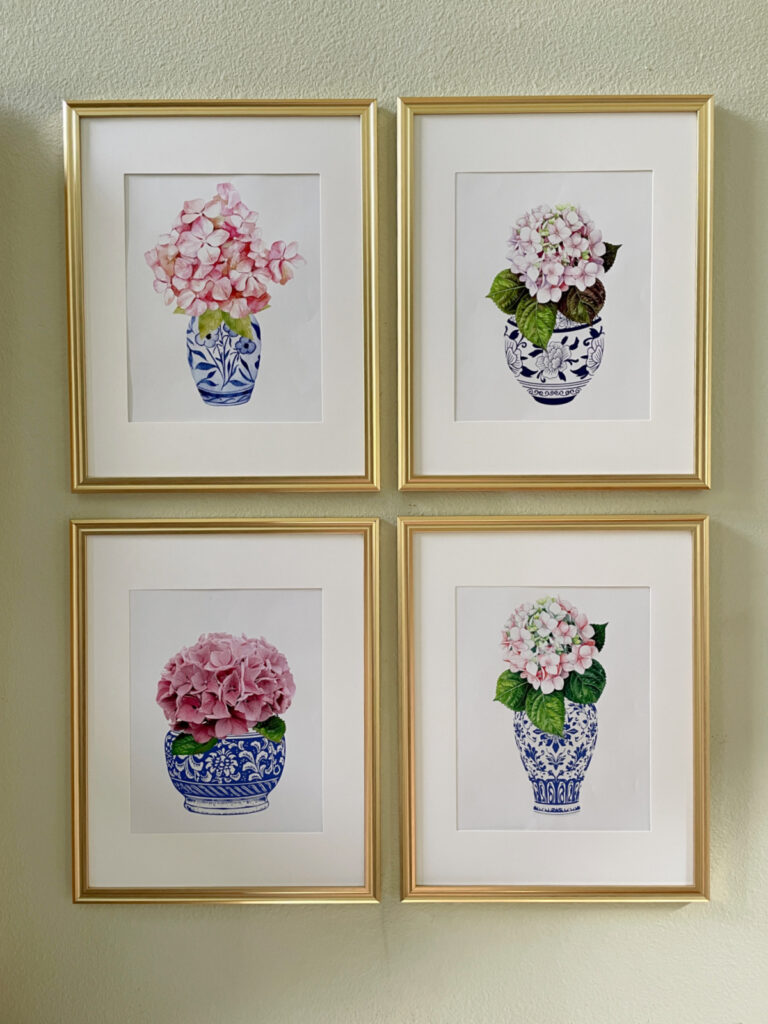 four printable artwork on wall with blue chioserie vases and pink hydrangeas