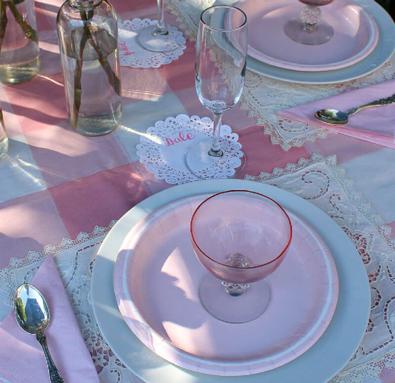 pink place setting with white doily placecard