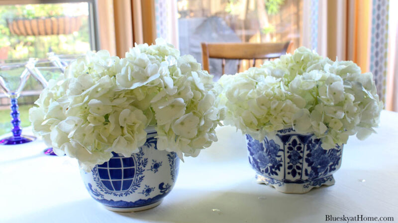 outdoor summer table decor blue planters with white hydrangeas