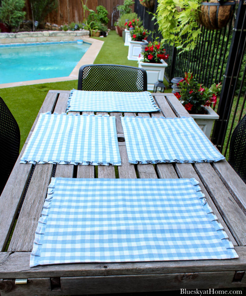 blue and white gingham placemats on outdoor summer table