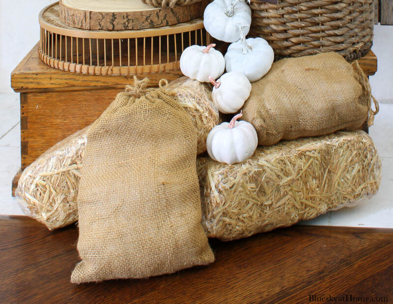 hay bales, burlap bags, white pumpkins