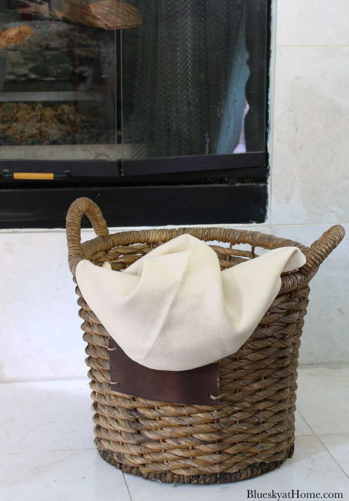 round woven basket with beige fabric