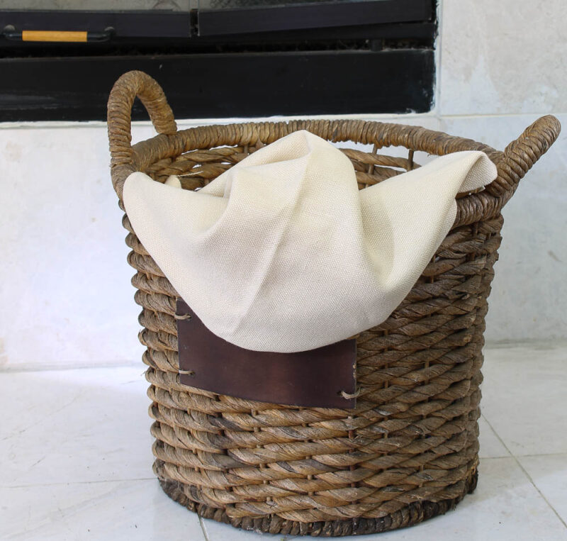 round woven basket with beige fabric