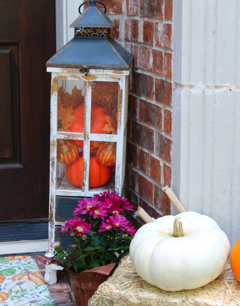 pumpkins and mums by fall front porch