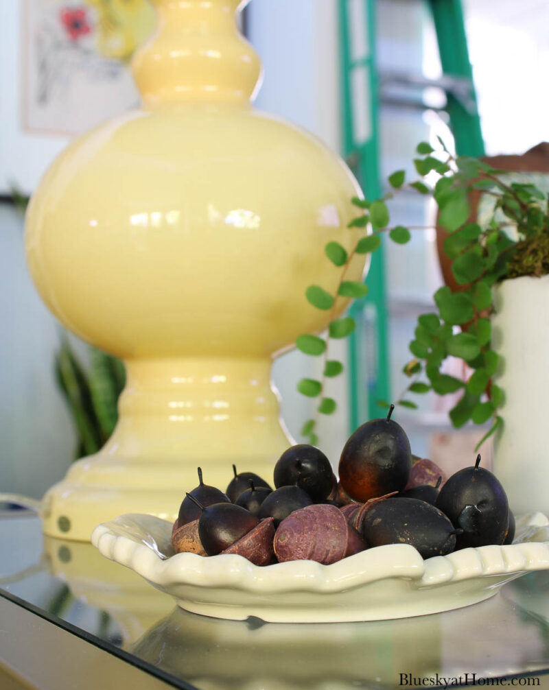 brown acorns in a cream dish