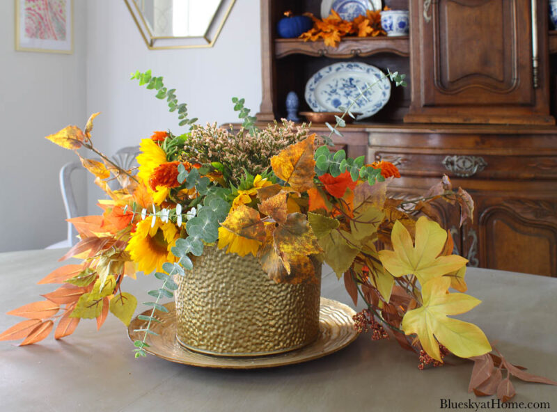 fall centerpiece with flowers and leaves