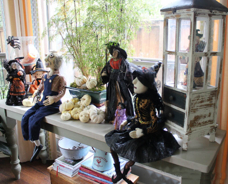 collection of witches and Halloween deocorations on table