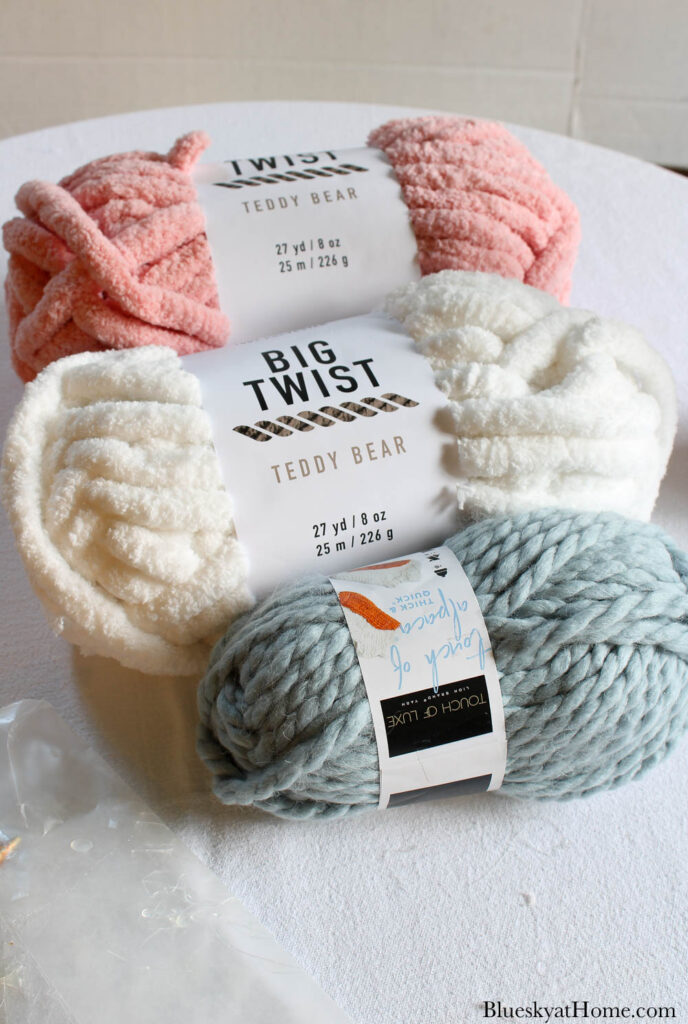 pink, white, and blue yarn