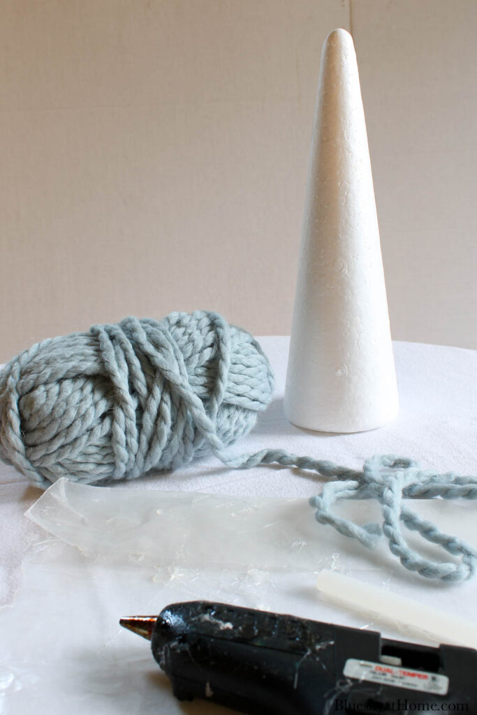 adding blue yarn yarn to styrofoam cone