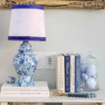 fabric-covered lamp shade with blue trim