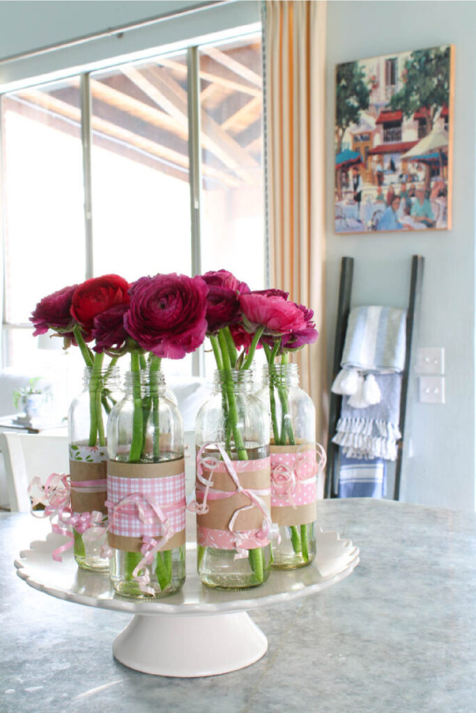 decorated glass bottles with pink paper and vinyl and ribbon