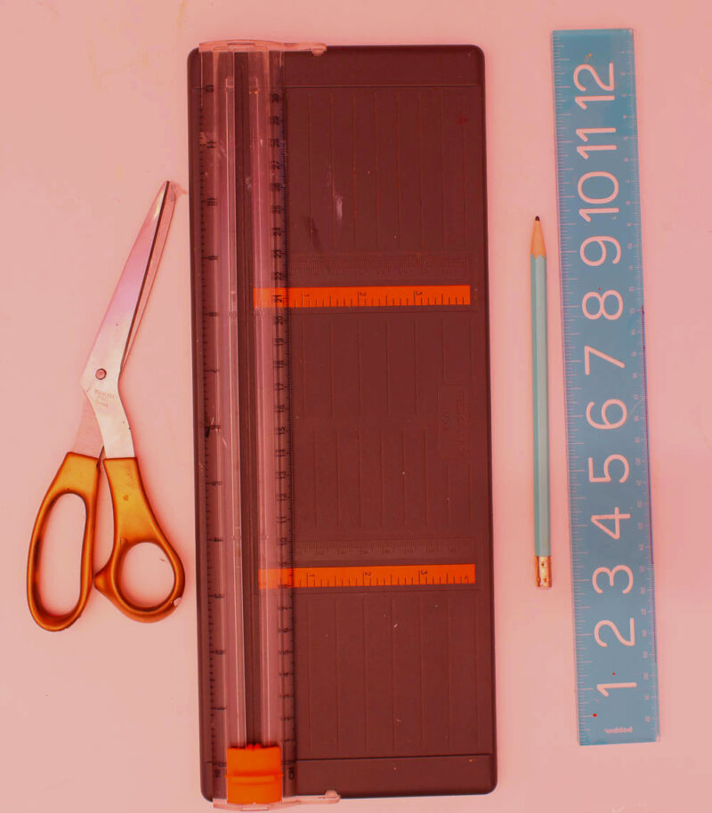 ruler, scissors, and paper cutter to make DIY luggage tags