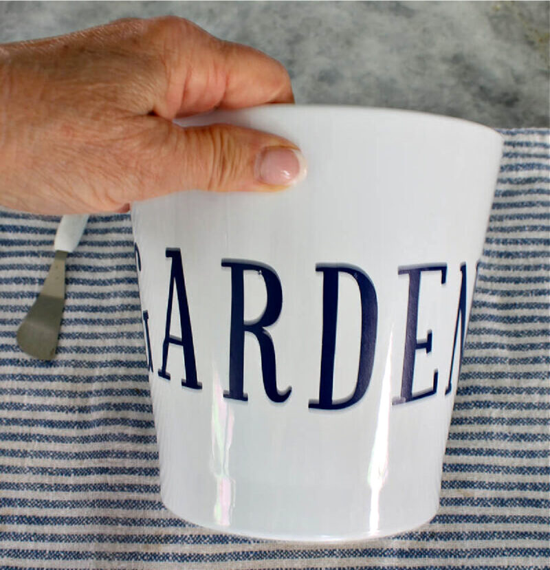 white ceramic planter with the word "garden"