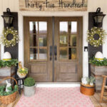 spring front door with pink rug and greenery
