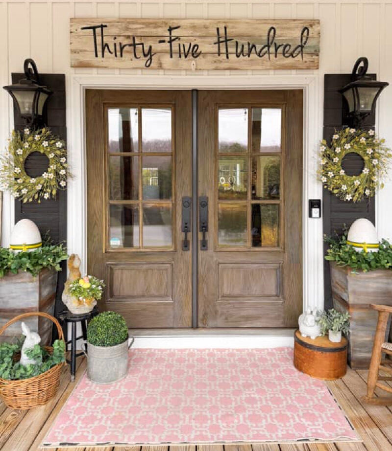 spring front door with pink rug and greenery