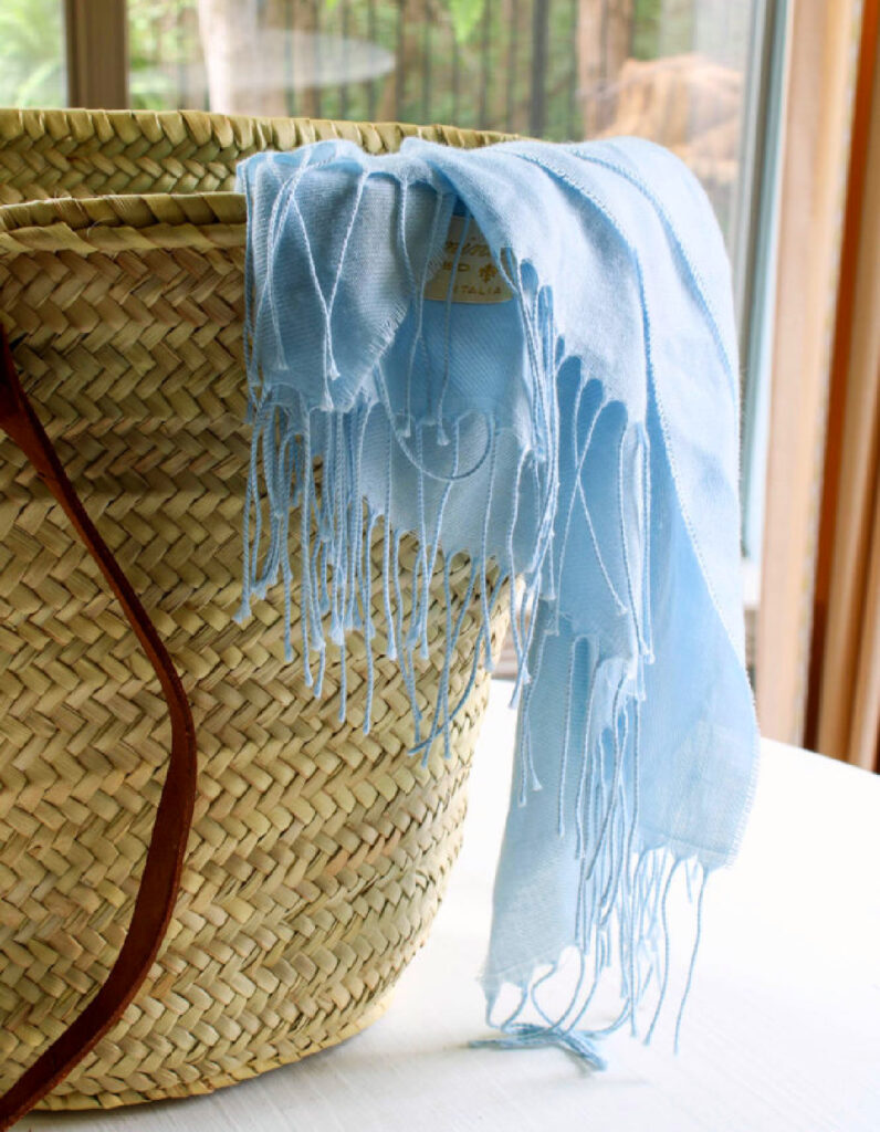 pale blue shawl in French woven tote basket bag with leather handles