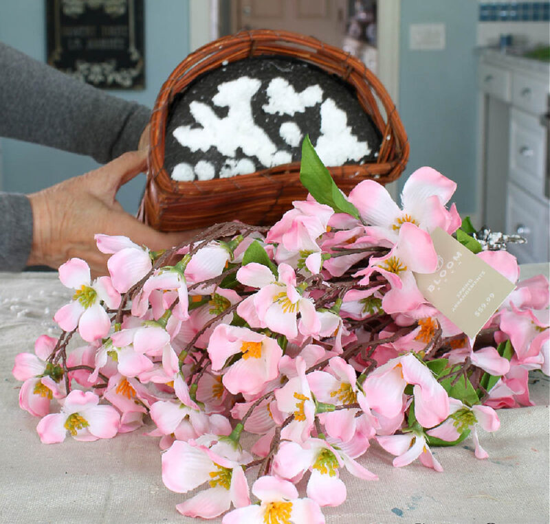 removing pink flowers and styrofoam from basket