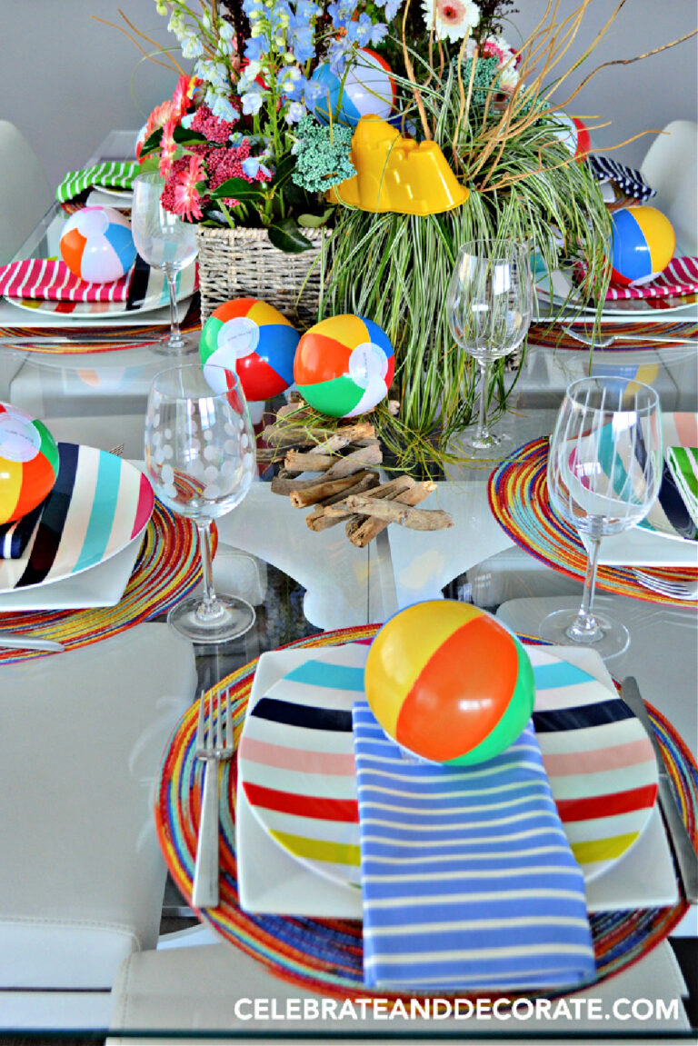 summer tablescape with beach balls and stripe plates