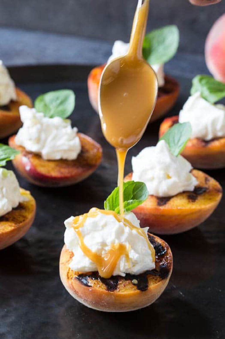 grilled peaches with whipped cream and carmel sauces