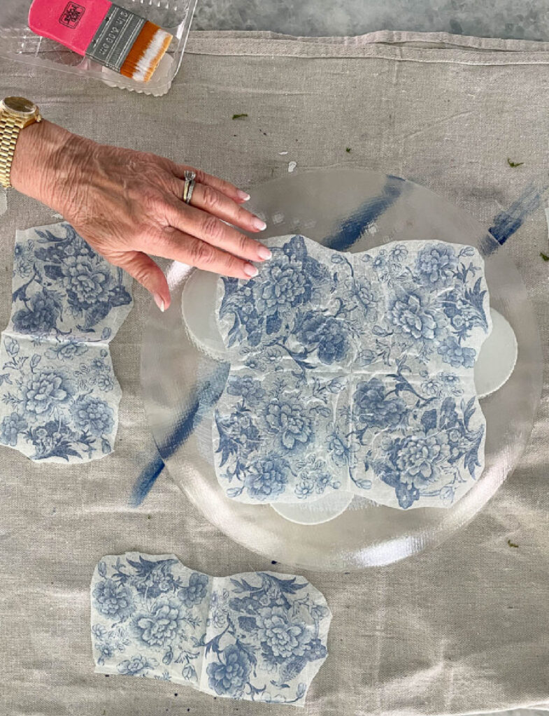 patting decoupage on glass platter