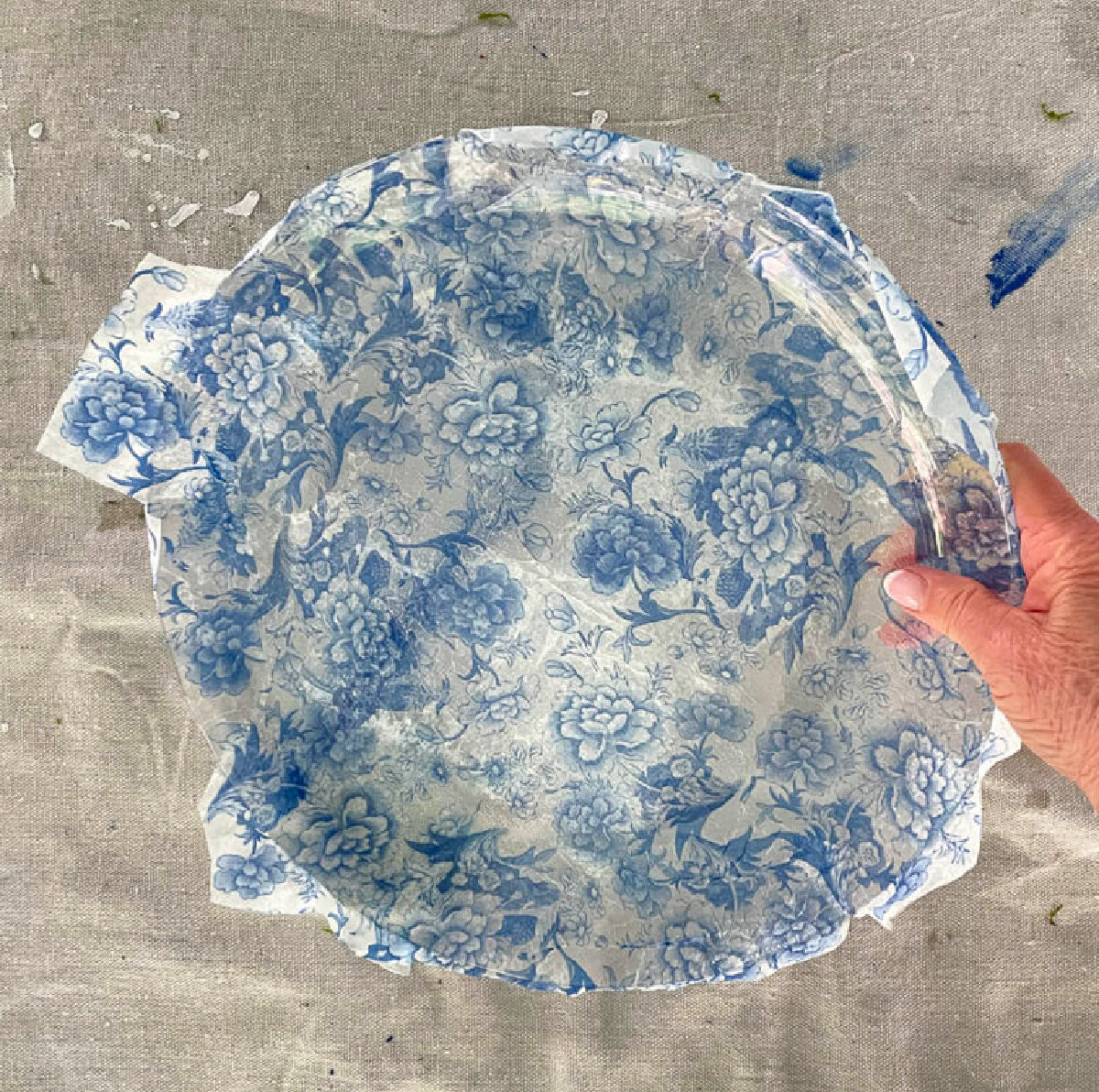holding decoupaged glass platter