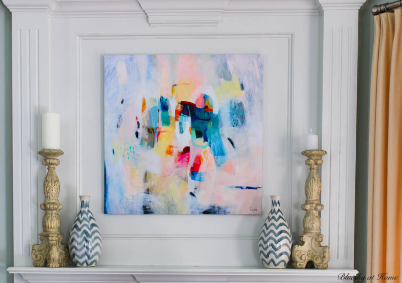 mantel with colorful abstract painting and blue and white vases
