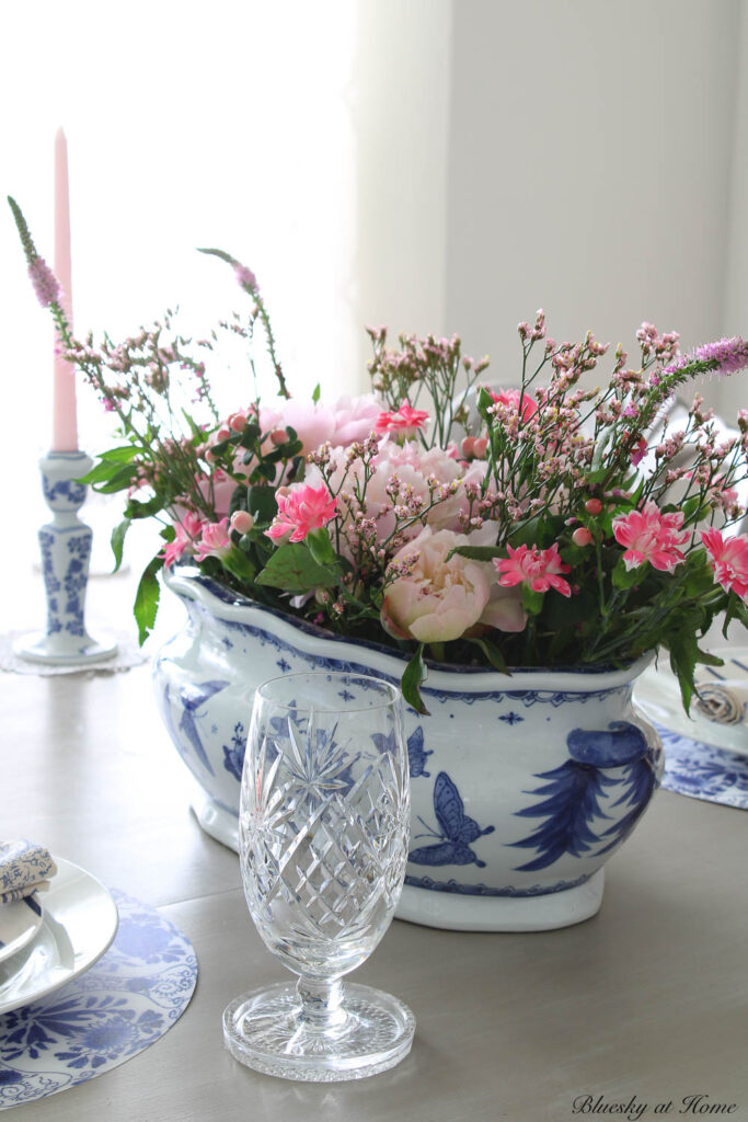 pink centerpiece in blue and white container