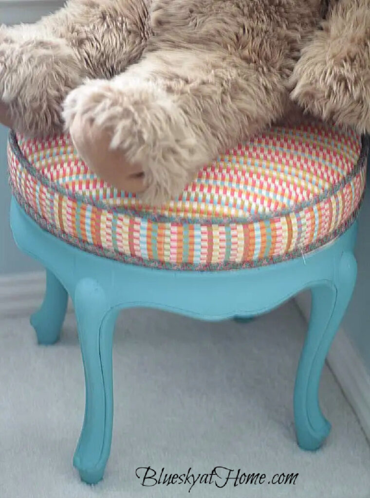 blue vanity stool with multi-colored fabric