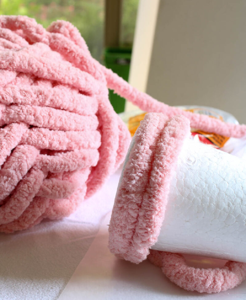 wrapping pink yarn around styrofoam cone