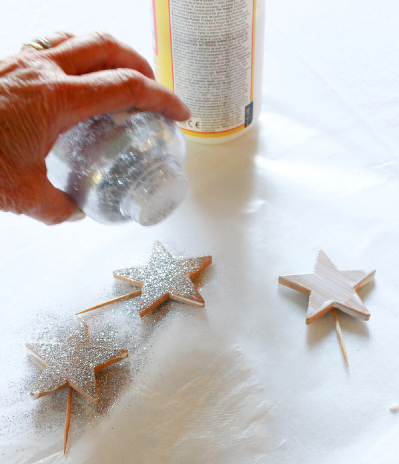 adding silver glitter to wood stars