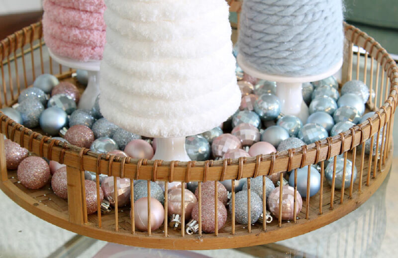 yarn Christmas trees in woven basket with small ornaments