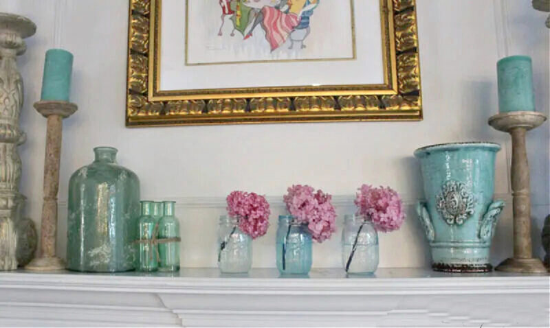 three tinted mason jars in blue with pink hydrangeas