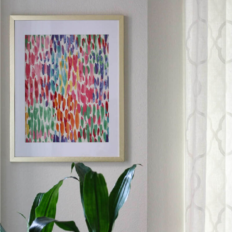 mutli-colored bright fabric in abstract pattern in frame on wall