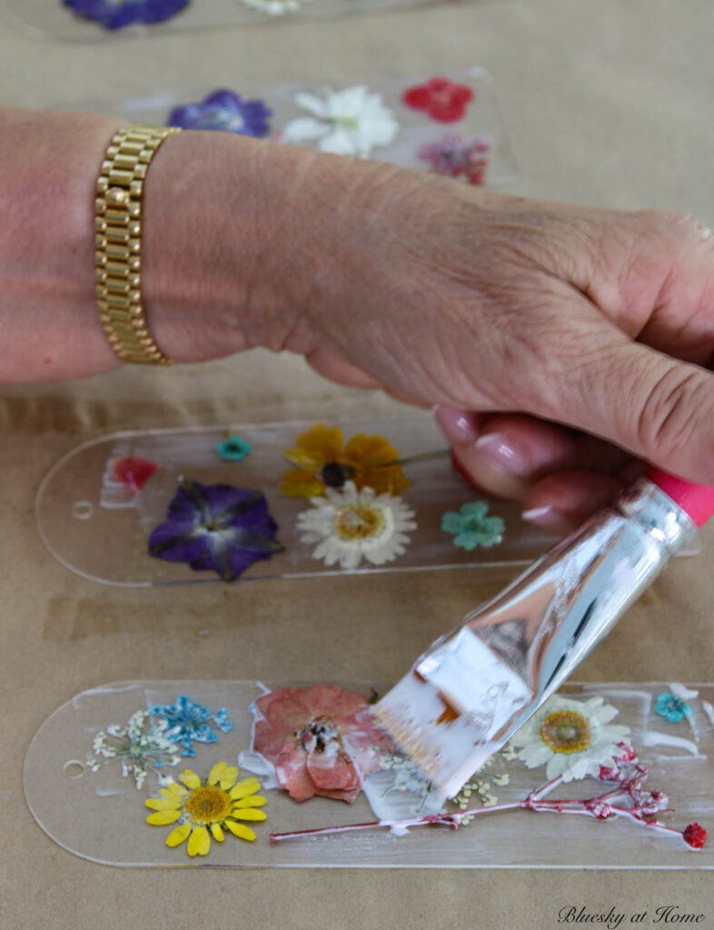 applying Mod Podge to pressed flowers