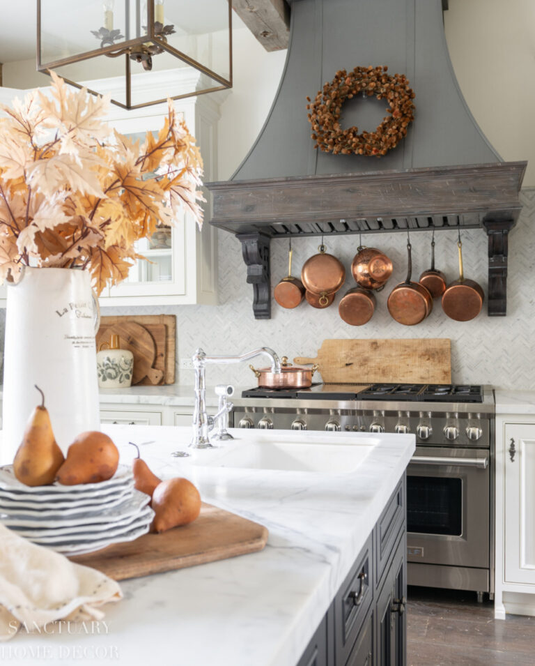 fall decor in kitchen with copper cookware and fall foliage