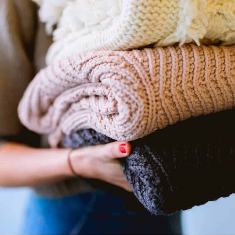 stack of organized sweaters for fall