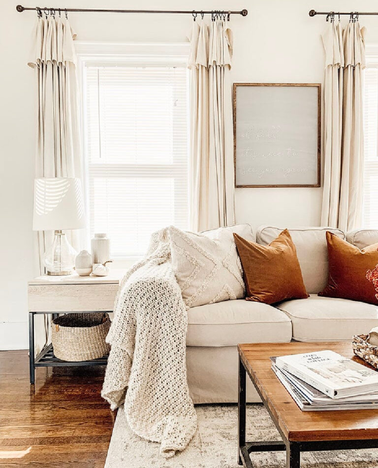 white sofa with rust-colored pillows for fall