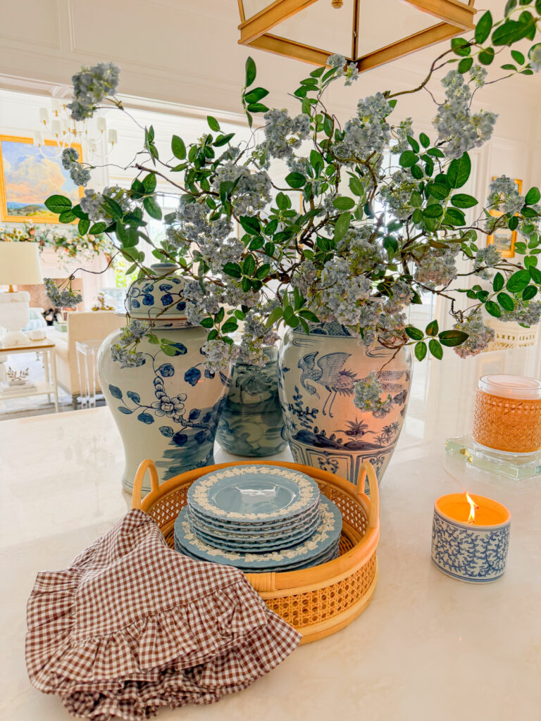 blue and white ginger jars with blue hydrangeas and brown gingham napkin